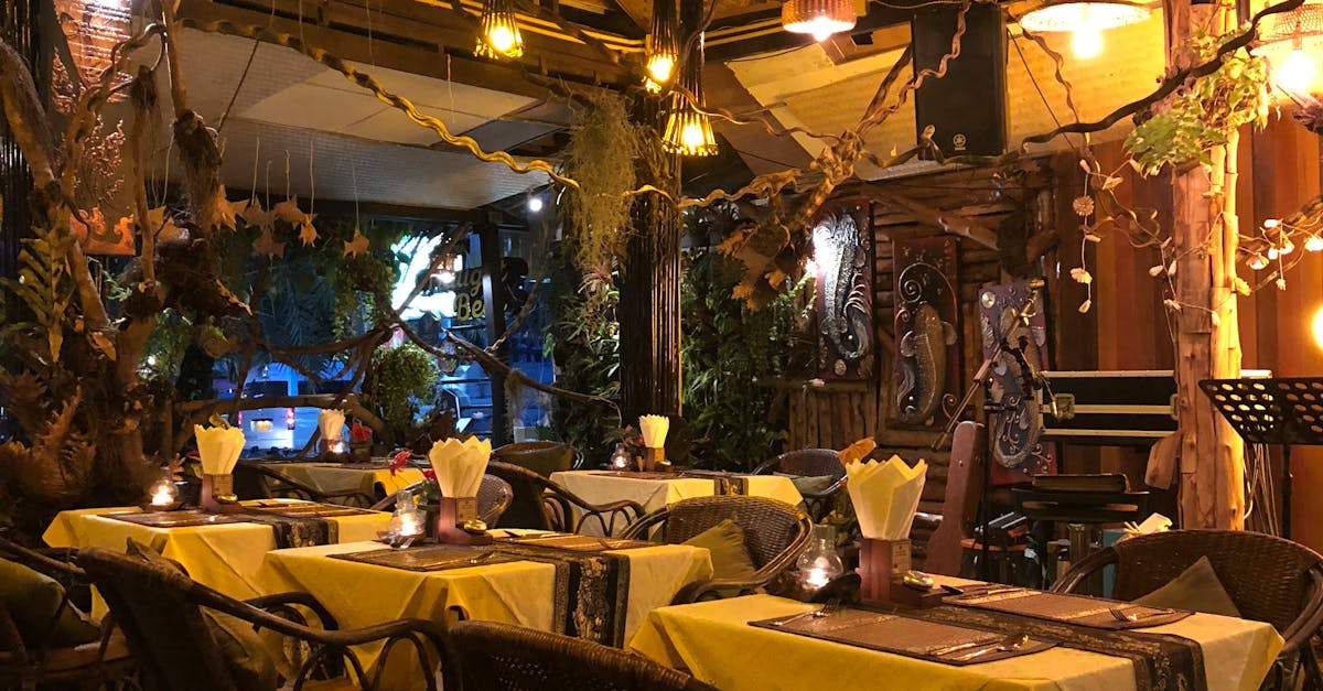 Charming rustic restaurant setting with warm lighting and decorative plants, perfect for a cozy dining experience.