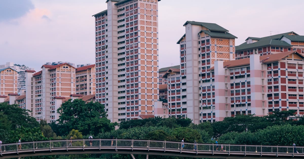 A view of Singapore's high-rise apartments with a pedestrian bridge and greenery.