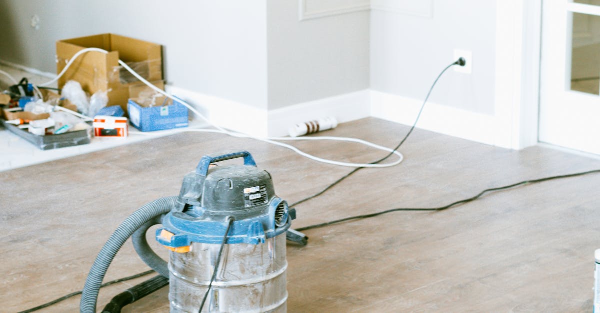 Vacuum and tools in a room undergoing renovation, showcasing home improvement.